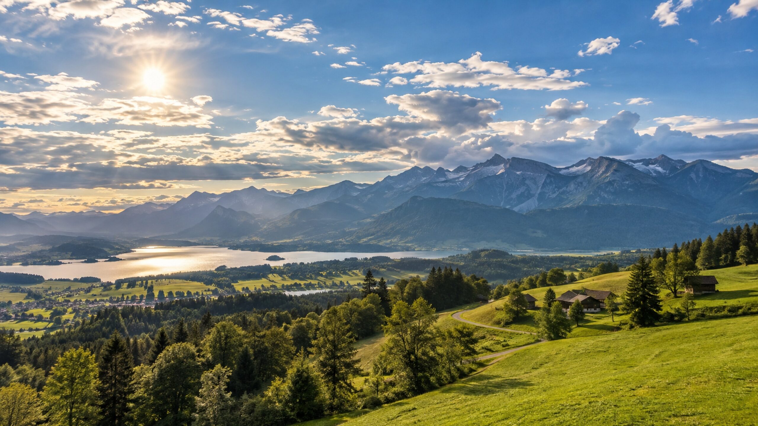 Warm late-summer weather over a central European Alpine lake with green hills and high mountains.